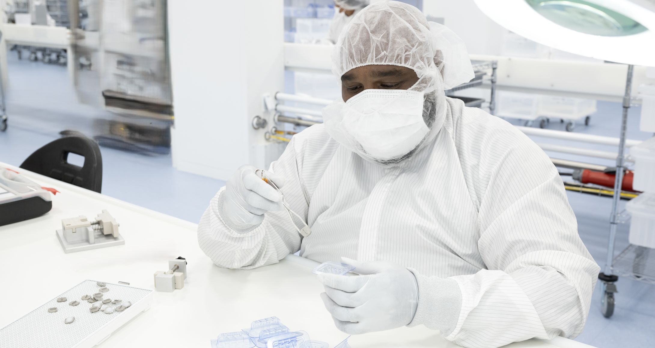 Man packaging spine implant to blister